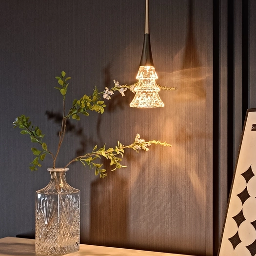 Matte black rise-and-fall pendant light with crystal tree diffuser, warm glow