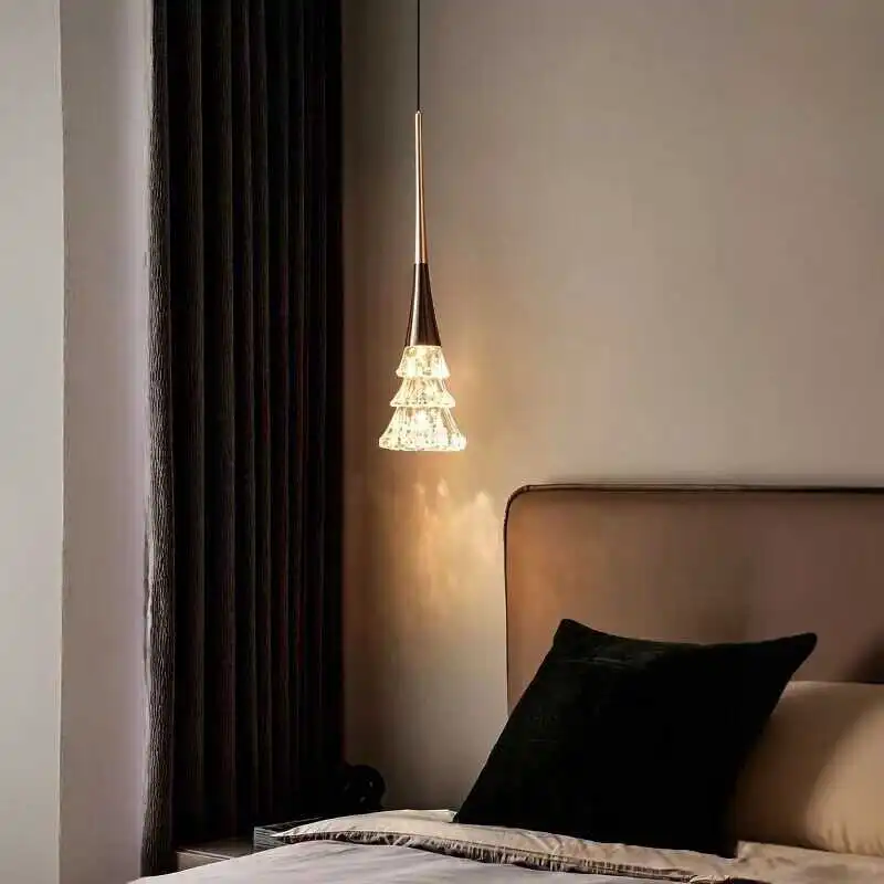 Matte black rise-and-fall pendant light with crystal tree diffuser, lit warm