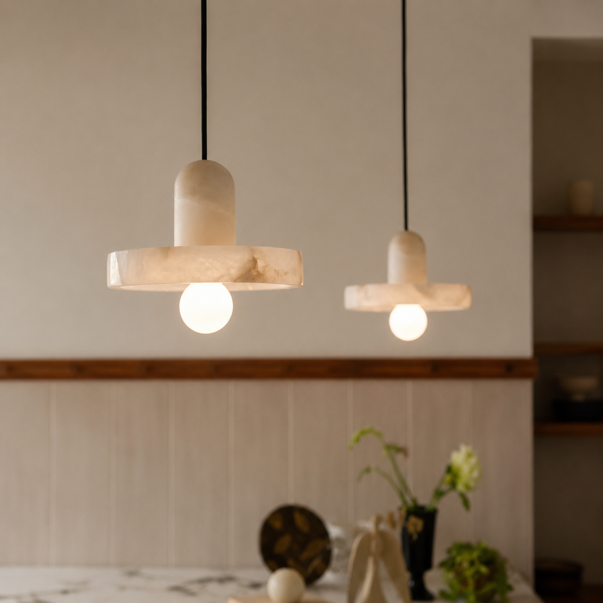 Alabaster fishline pendant light with cylindrical shades, stone crossbar, and globe bulbs