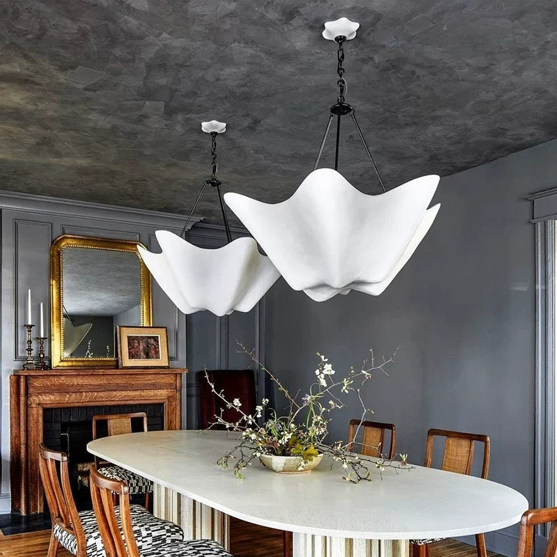 Chalk-white plaster chandelier with five petal shades on black cords, paired