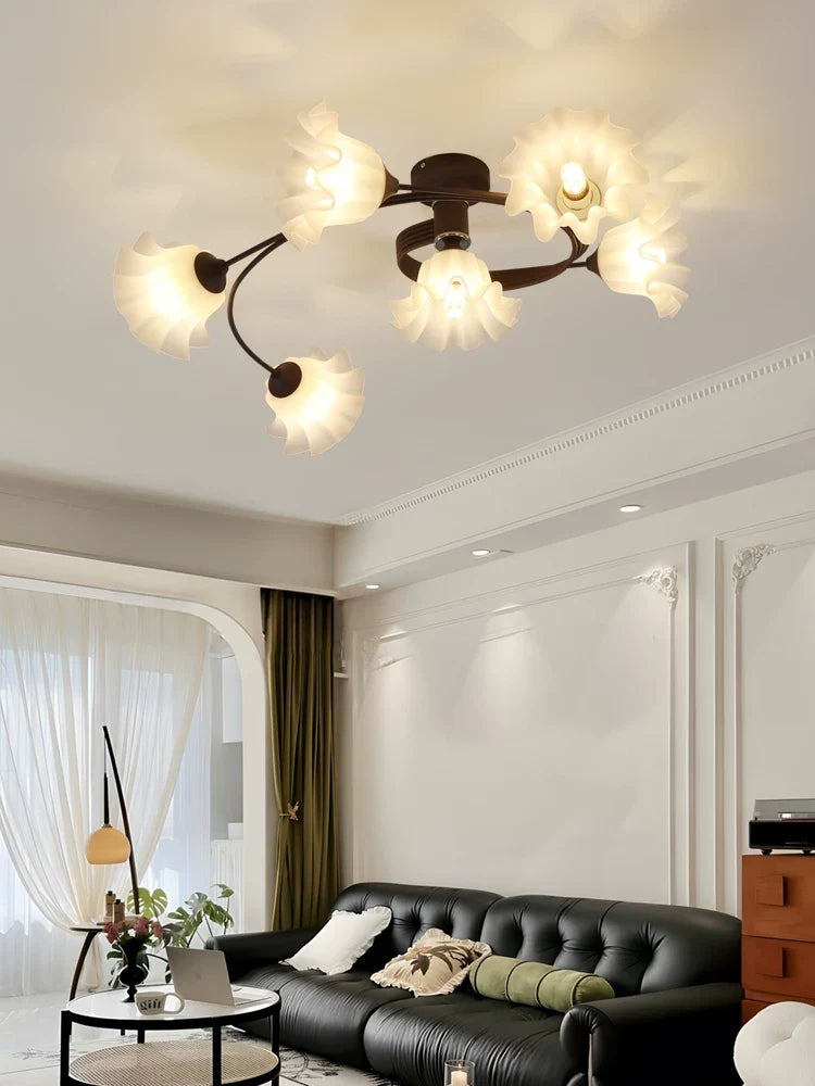 Black semi-flush chandelier with curved arms and frosted flower shades