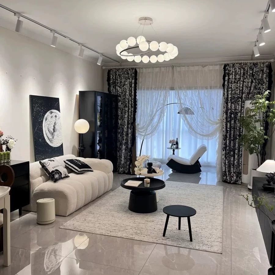 Pearl chandelier with white globe shades in a spiral ring design over living room