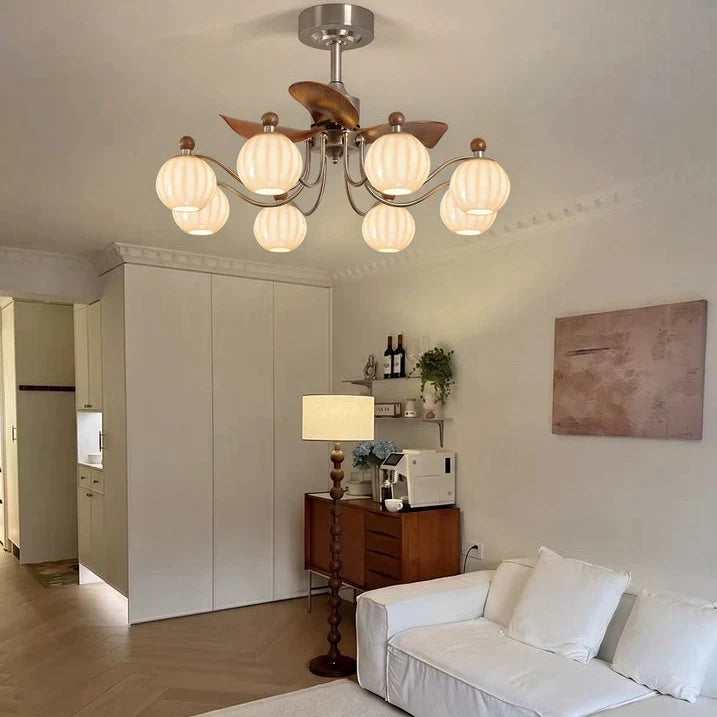 Bronze and silver-toned 8-light ceiling fan chandelier with frosted glass globes