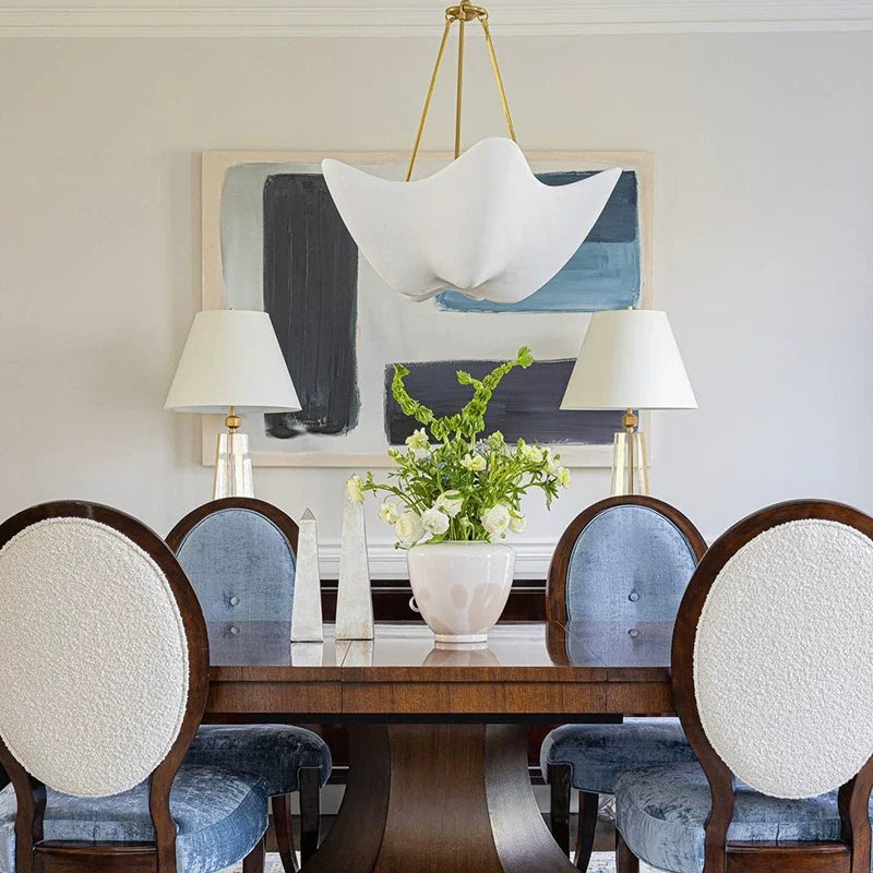 Chalk-white plaster chandelier with five petal shades and gold chain, suspended
