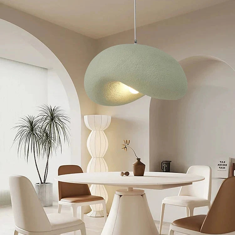 Light green organic disc pendant light with fabric-wrapped shade and hanging cord