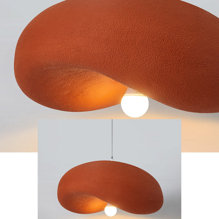 Warm coral organic disc pendant light close-up showing textured fabric shade