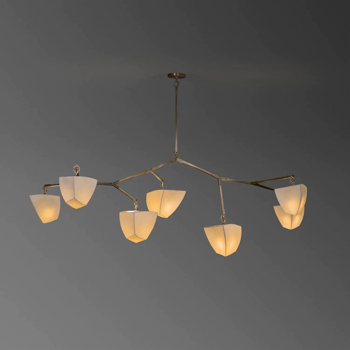 Brass branching chandelier with eight off-white cone shades in a circular arm layout