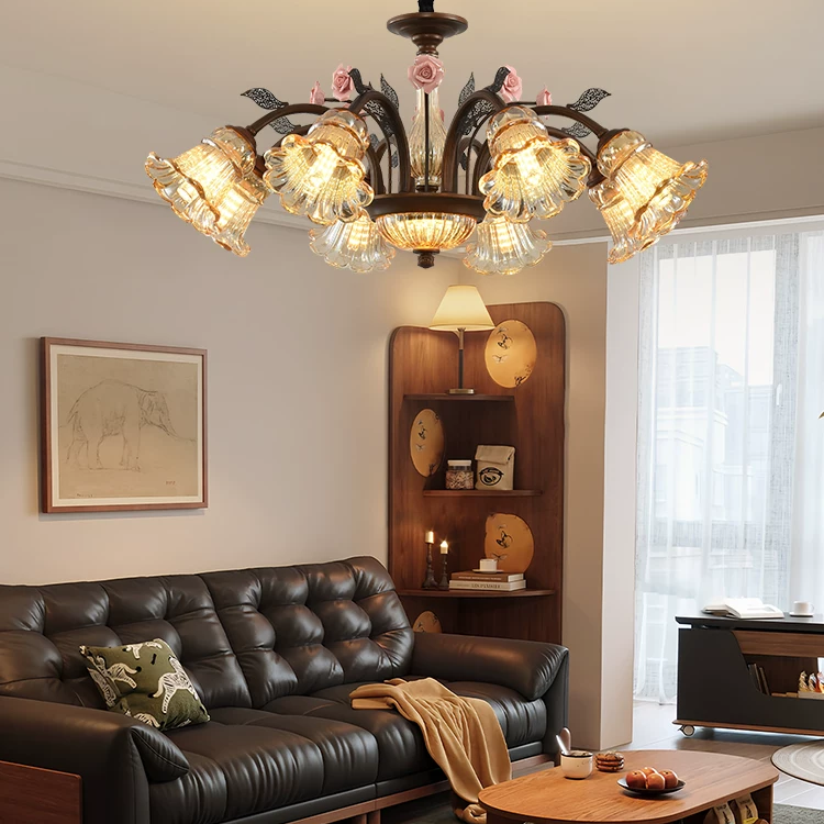 American vintage rose blossom chandelier with bronze arms, pink roses, and illuminated clear glass shades