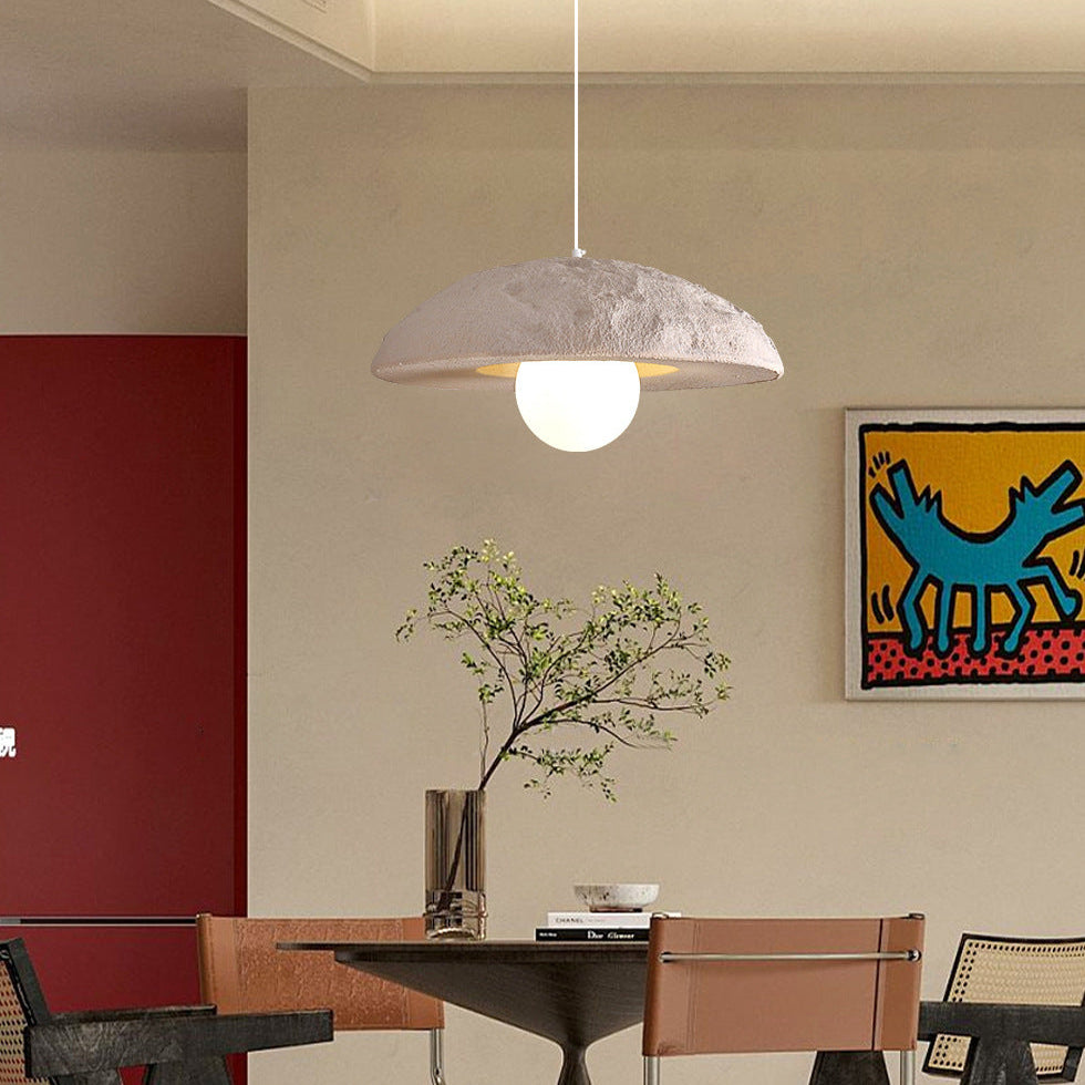 Ivory dome pendant light with textured beige dome shade and glowing bulb