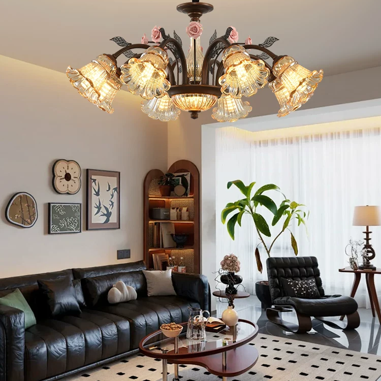 American vintage rose blossom chandelier with curved bronze arms, pink roses, and glowing clear glass shades
