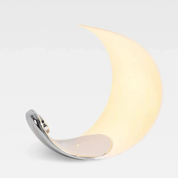 Crescent moon table lamp with white shade and shiny chrome crescent stand