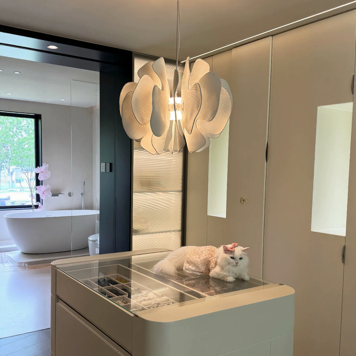Ceramic petal chandelier above a vanity area with layered white petal shades glowing