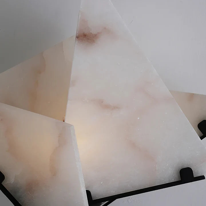 Close-up of black metal arm and alabaster star shade with marble veining