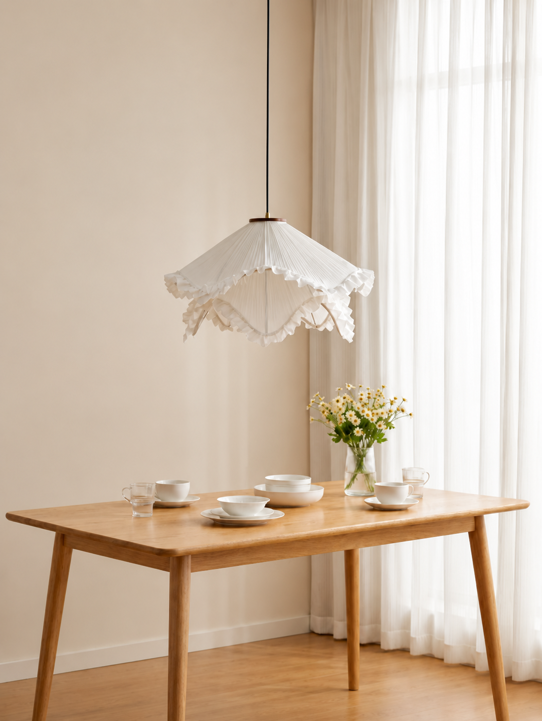 Cream pleated fabric pendant light shade with scalloped ruffle trim above a dining table