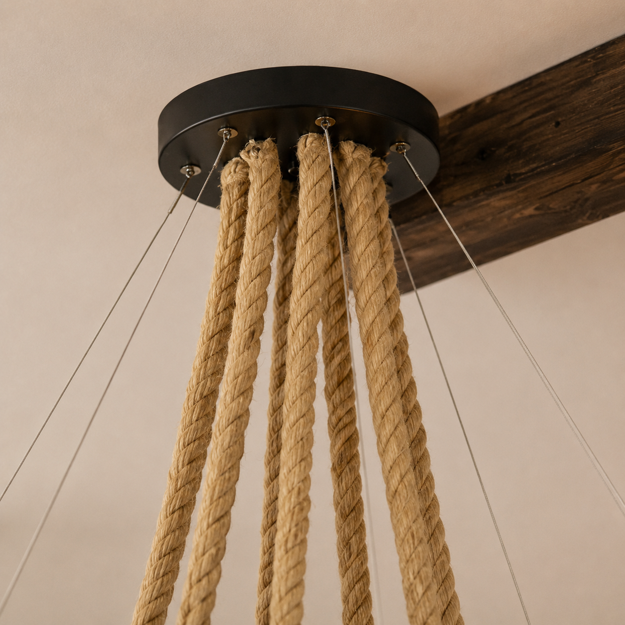 Rope-suspended canopy for a woven rattan cluster pendant light with hanging cords.
