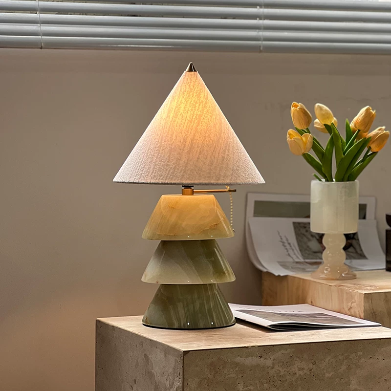 Carved jade-style tree table lamp with stacked conical shades on brass base.