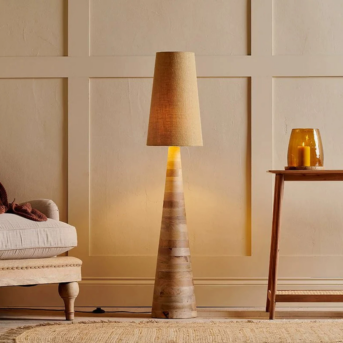 Wood floor lamp with linen drum shade and tapered carved column base