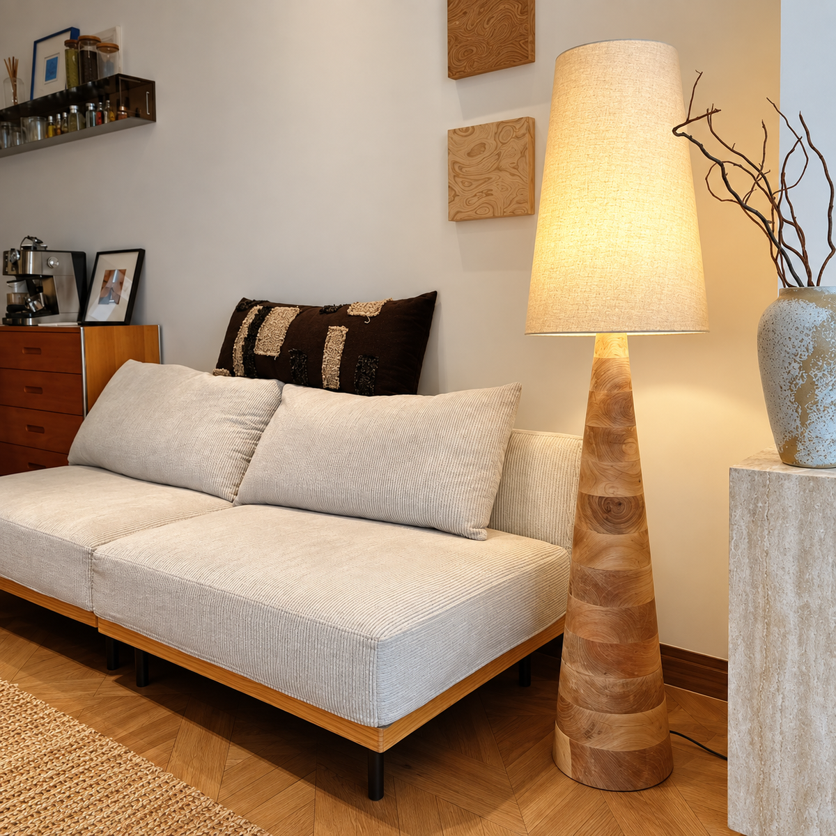 Wood floor lamp with beige drum shade and tall carved taper base