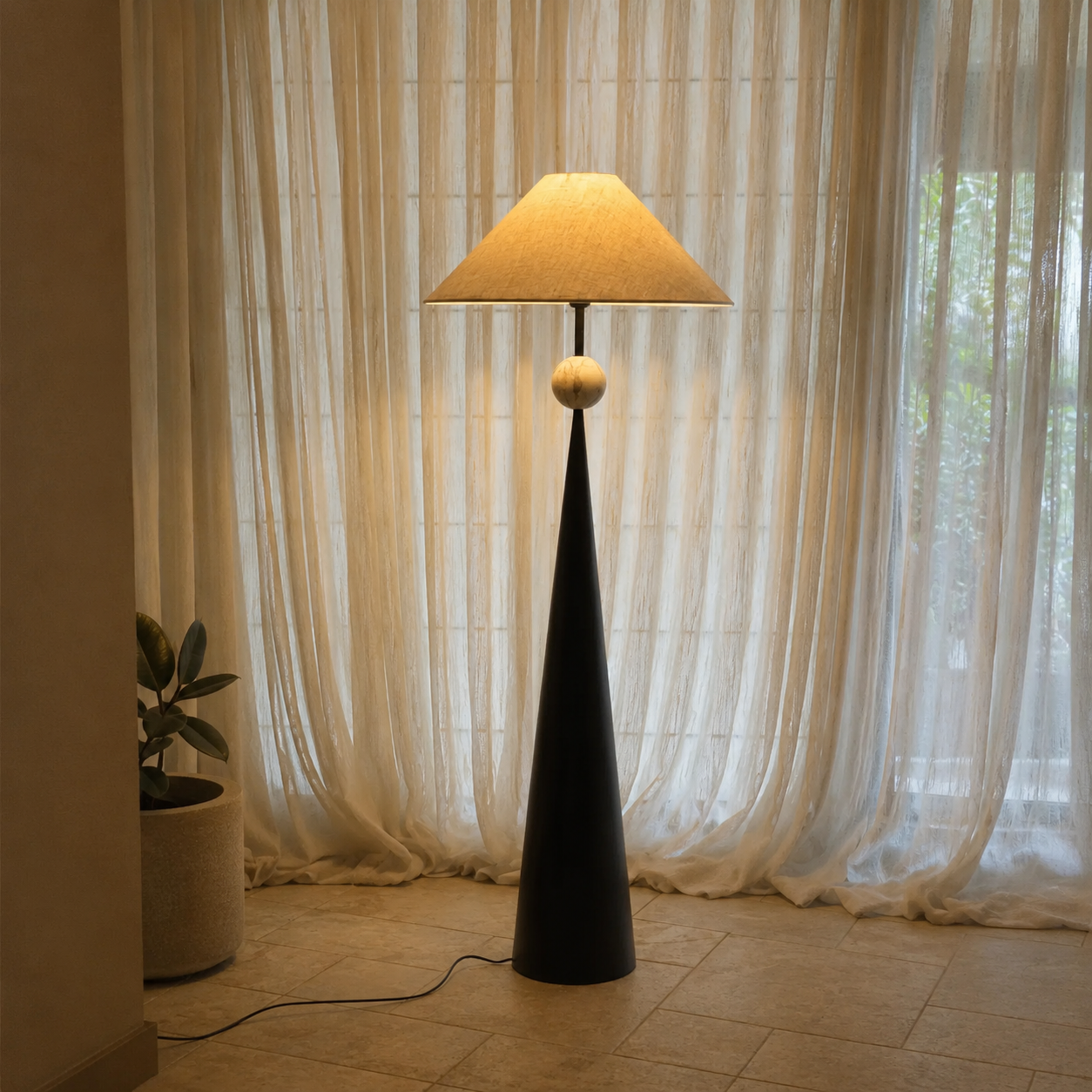 Black floor lamp with beige linen shade and round finial, photographed from front.