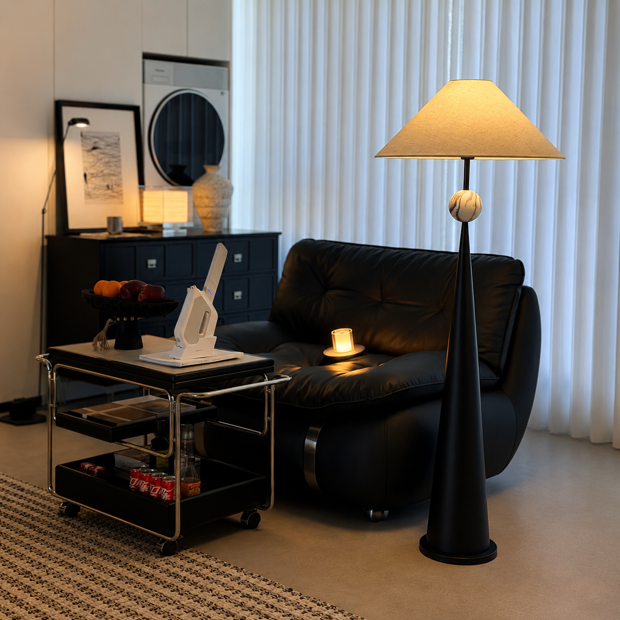 Black floor lamp with beige linen shade and spherical finial on tapered body.