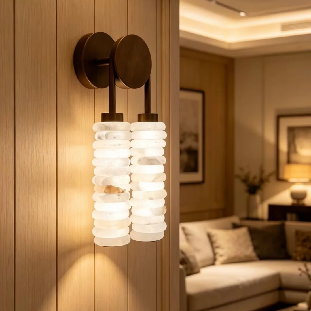 Tiered alabaster wall sconce featuring two vertical stacked alabaster shades on bronze mounts