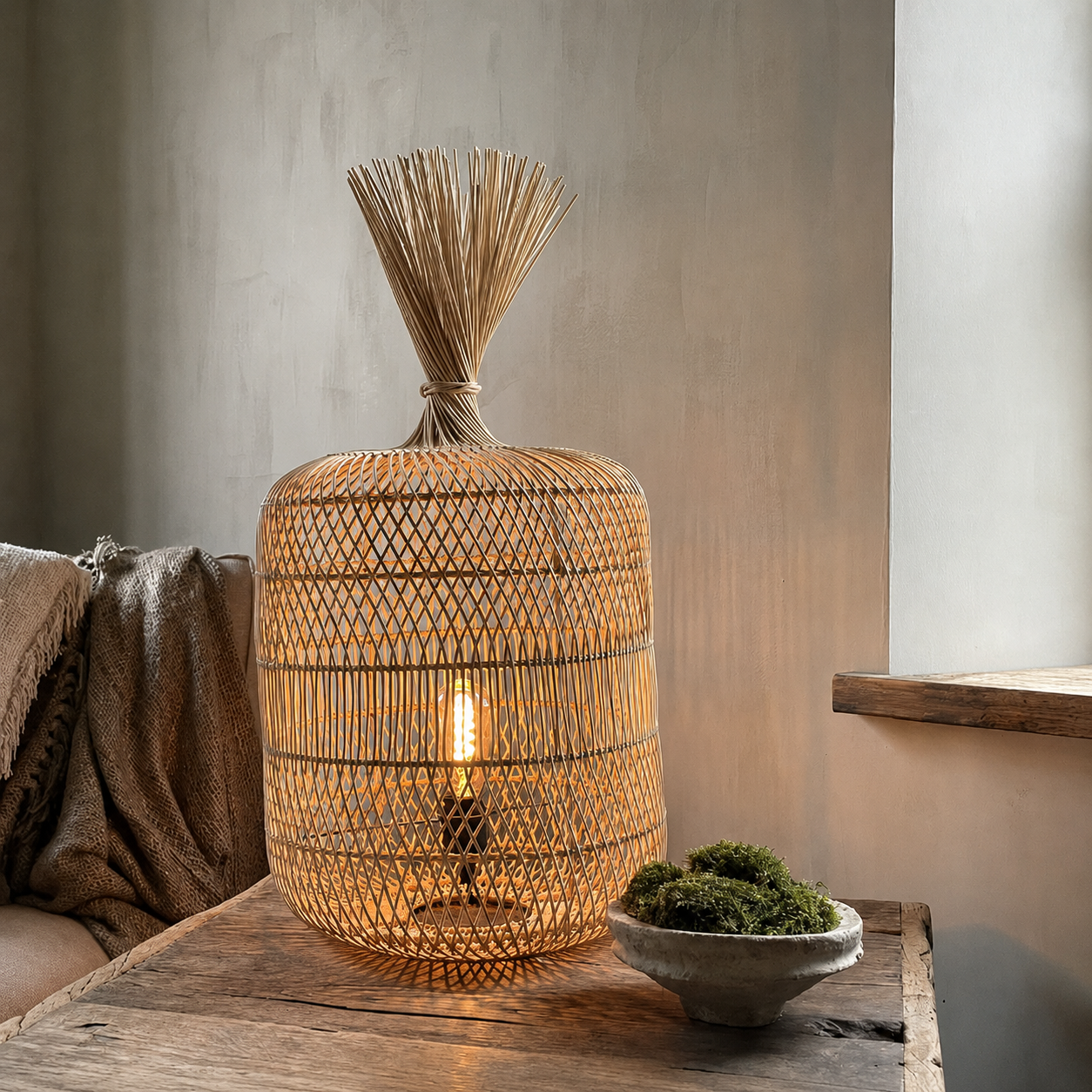 Natural rattan floor lamp on side table, woven shade glowing warm light with reed top