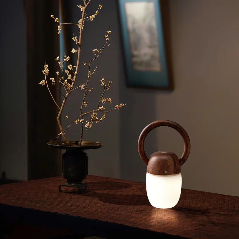 Wood ring-handle lantern with frosted white glass and warm glow