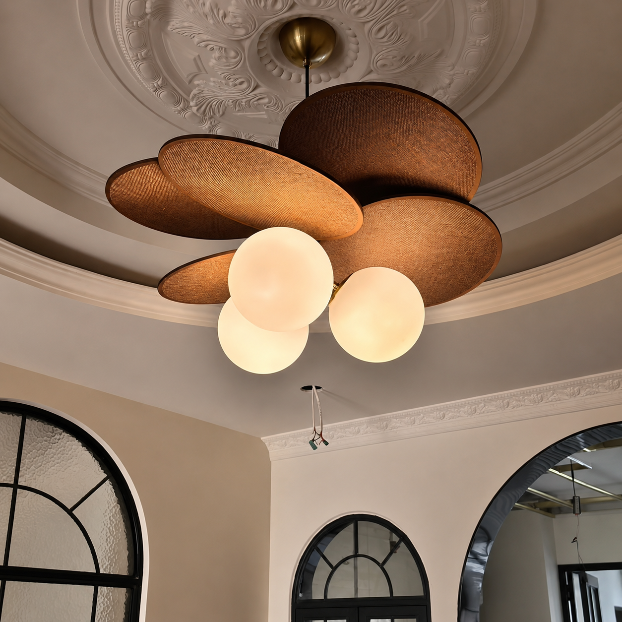 Petal pendant light with rust-brown fabric petals and three glowing white globe bulbs.