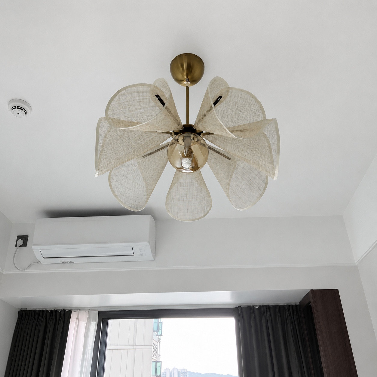 Brass-stem linen chandelier with six petal shades and centered bulb light