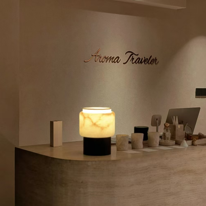 Walnut table lamp with frosted white shade on dark wood base