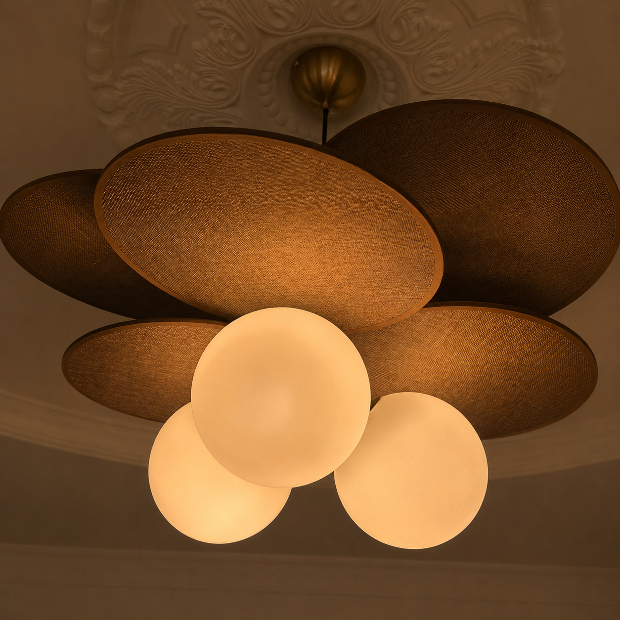 Petal pendant light with dark brown fabric shades and warm-lit white globe bulbs.