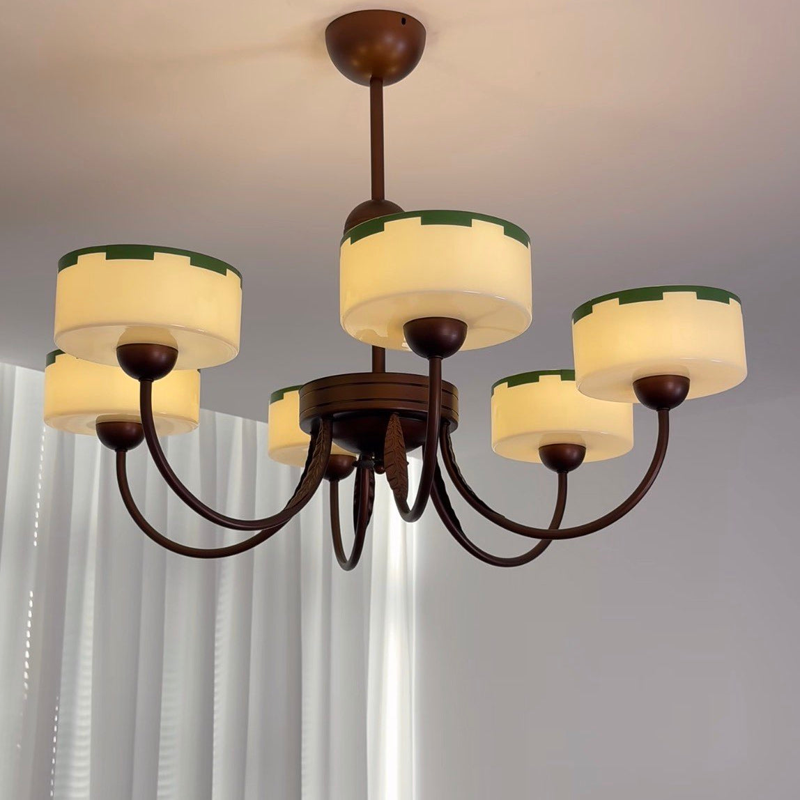 Chandelier with five opal glass shades, dark metal arms, and round canopy