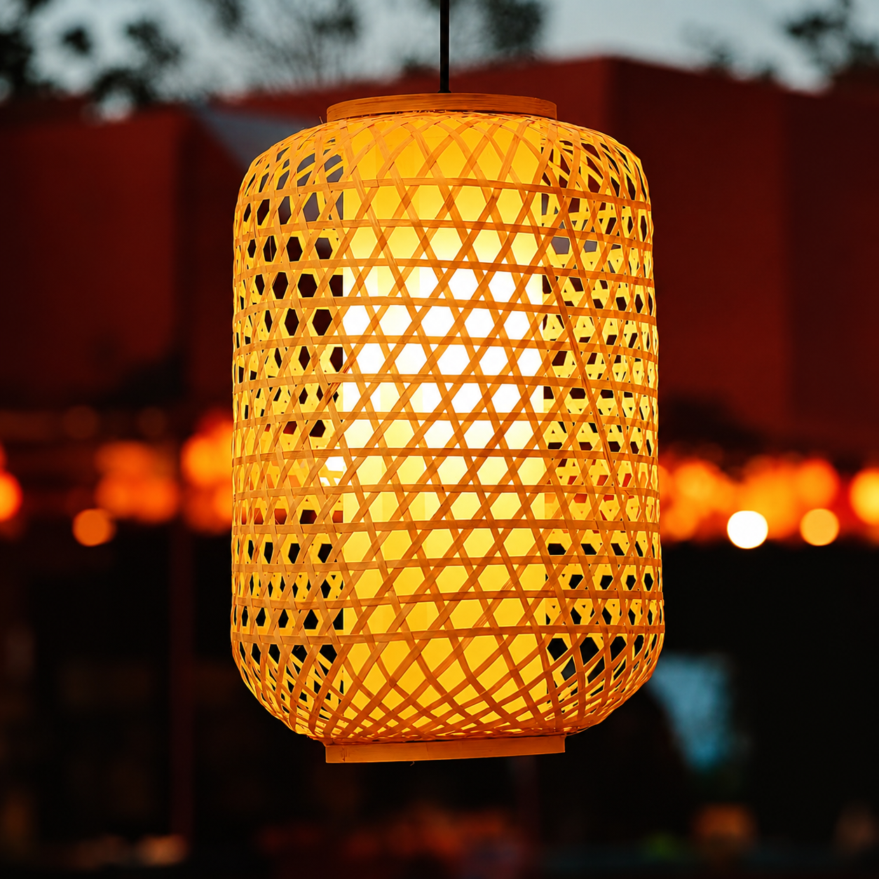 Hanging cylindrical woven golden lantern shade with geometric grid lattice and warm light