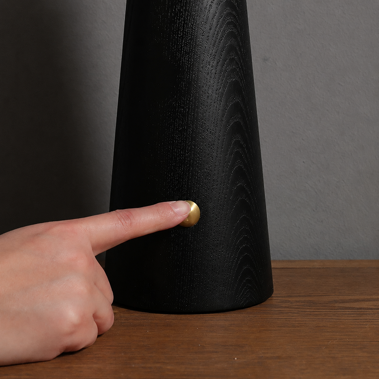 Cloud glass table lamp base close-up in matte black with brass detail