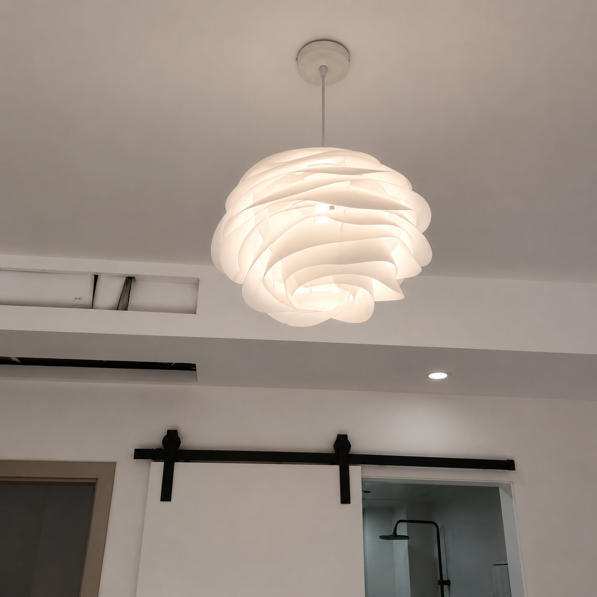 White petal swirl pendant light with layered curved petals and ceiling mount