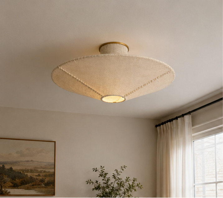 Beige fabric flush mount ceiling light with warm glow under woven shade
