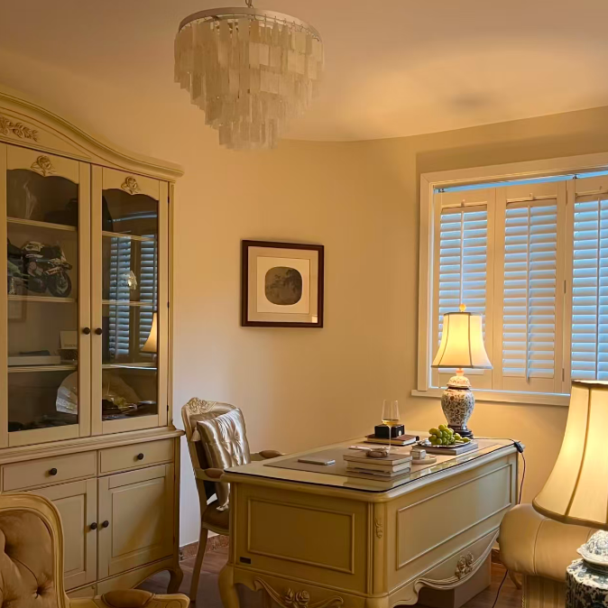 Capiz shell tiered chandelier above office desk