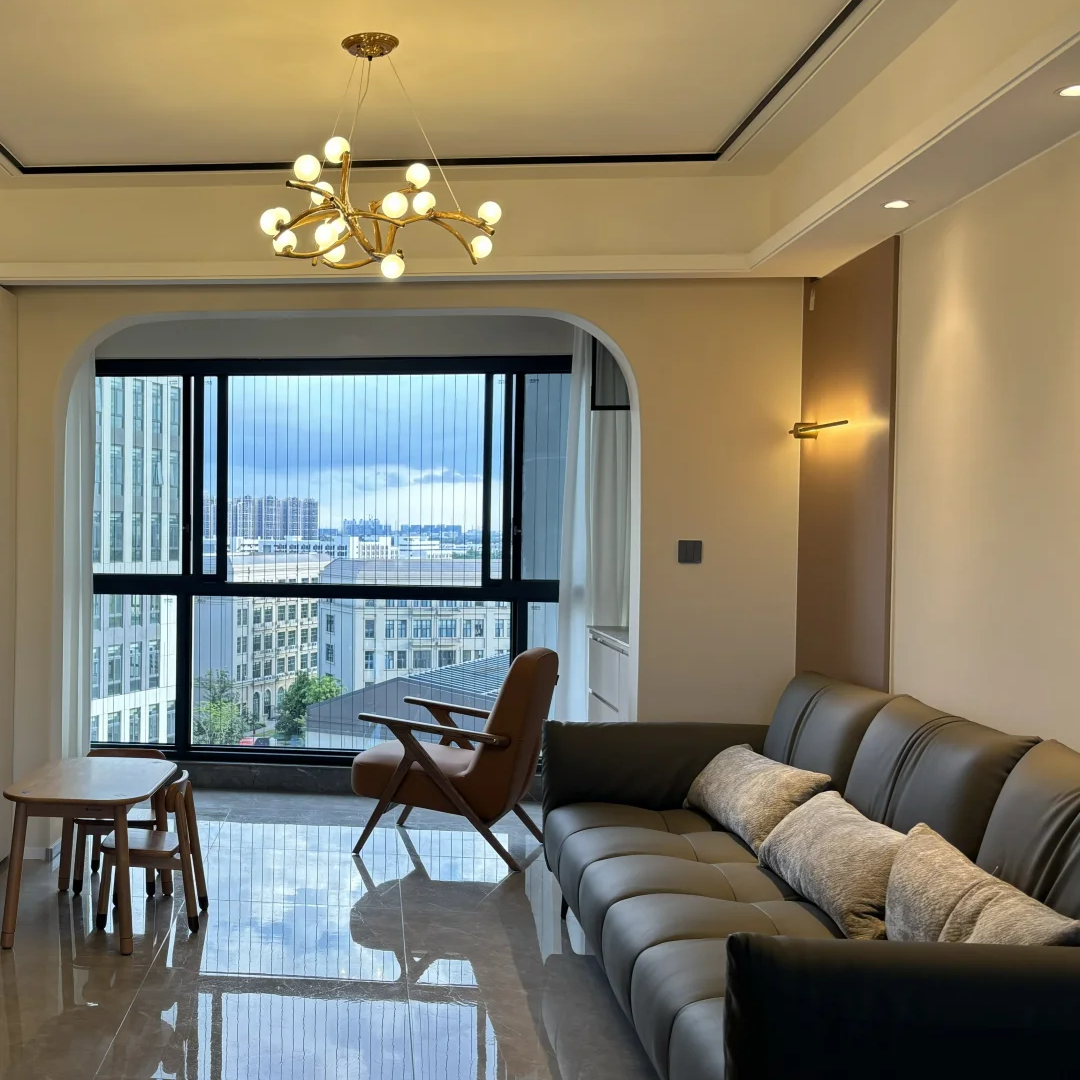Gold branch chandelier with small white globe bulbs clustered across curving metal arms