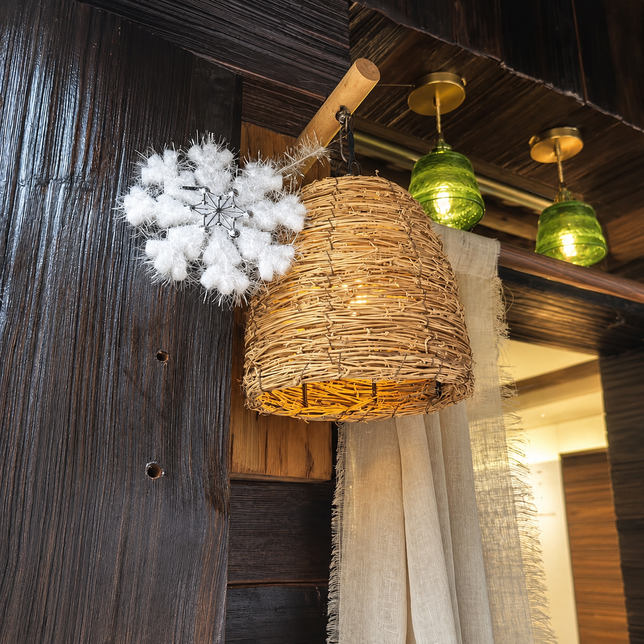 Woven rattan wall lantern on dark wood mount, with warm light and hanging chains