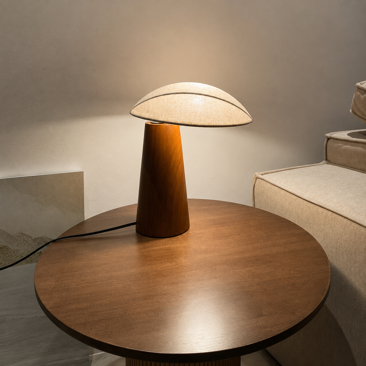 Wood table lamp with off-white linen shade on a wide round base