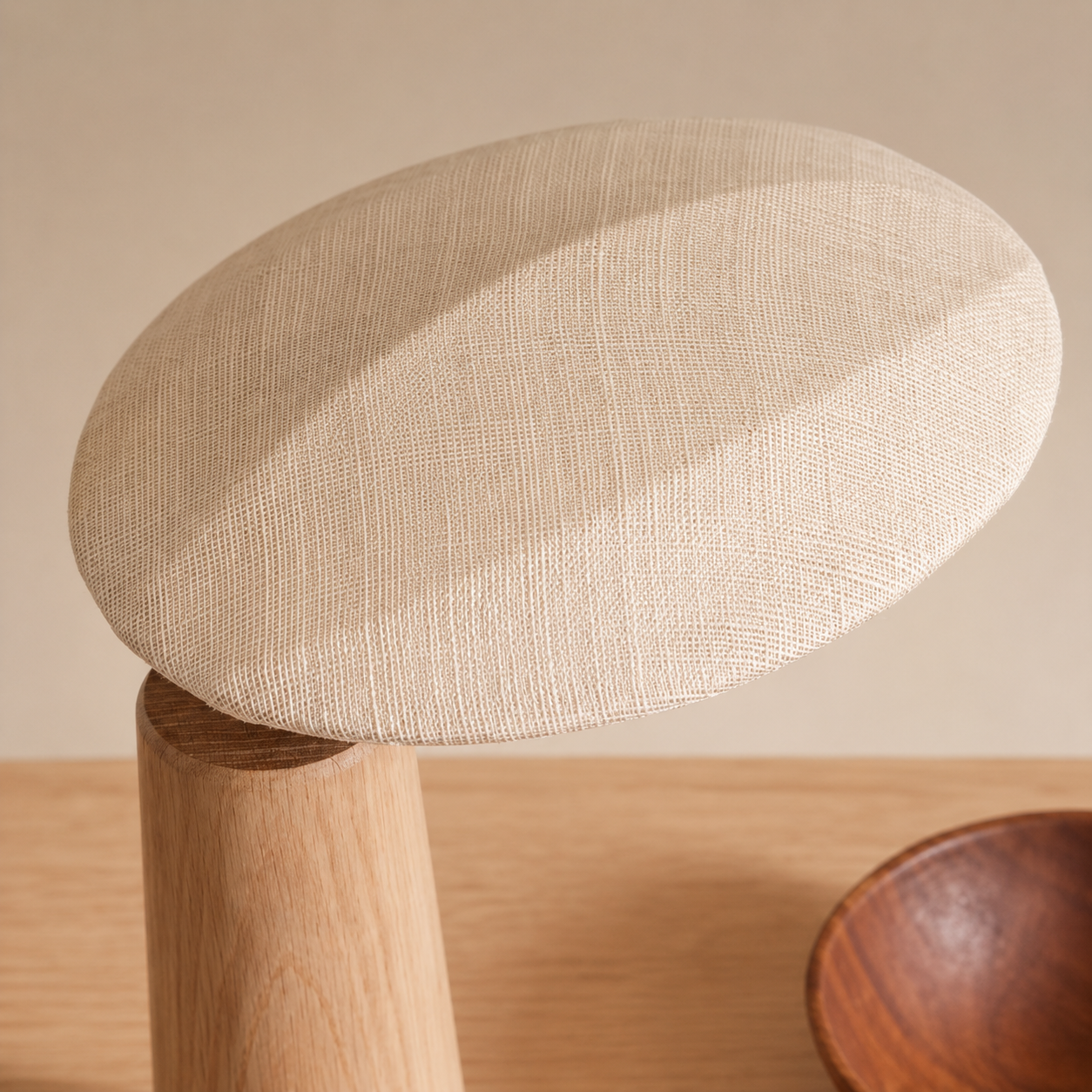 Linen dome lamp shade on a light wood cylindrical base