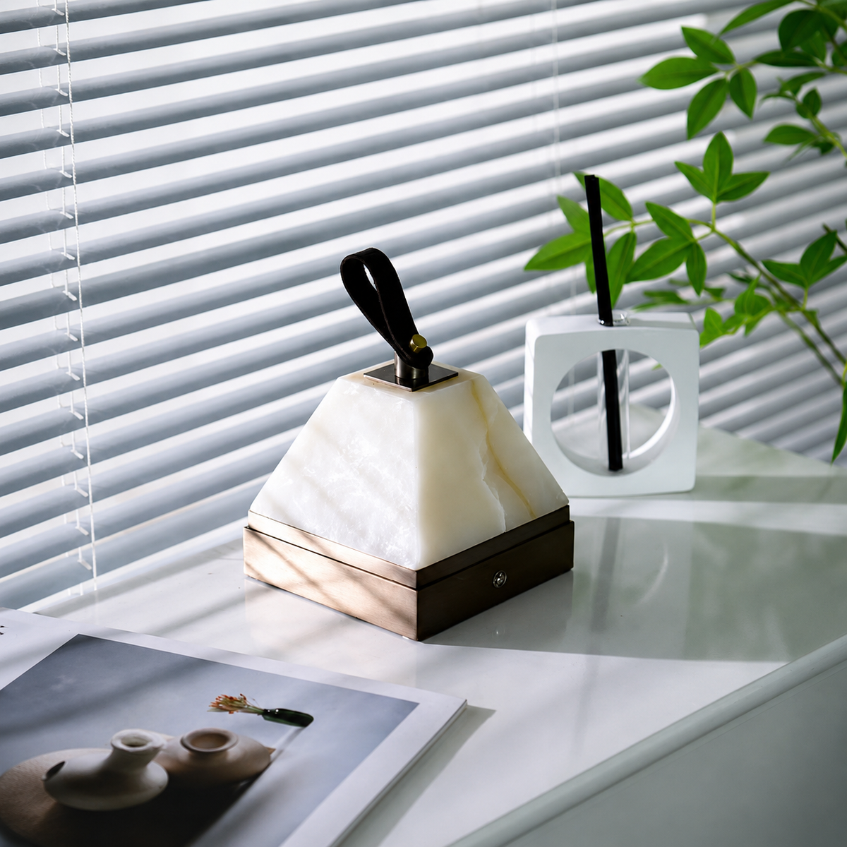 Pyramid alabaster portable table lamp with white pyramid shade and dark base, black stem