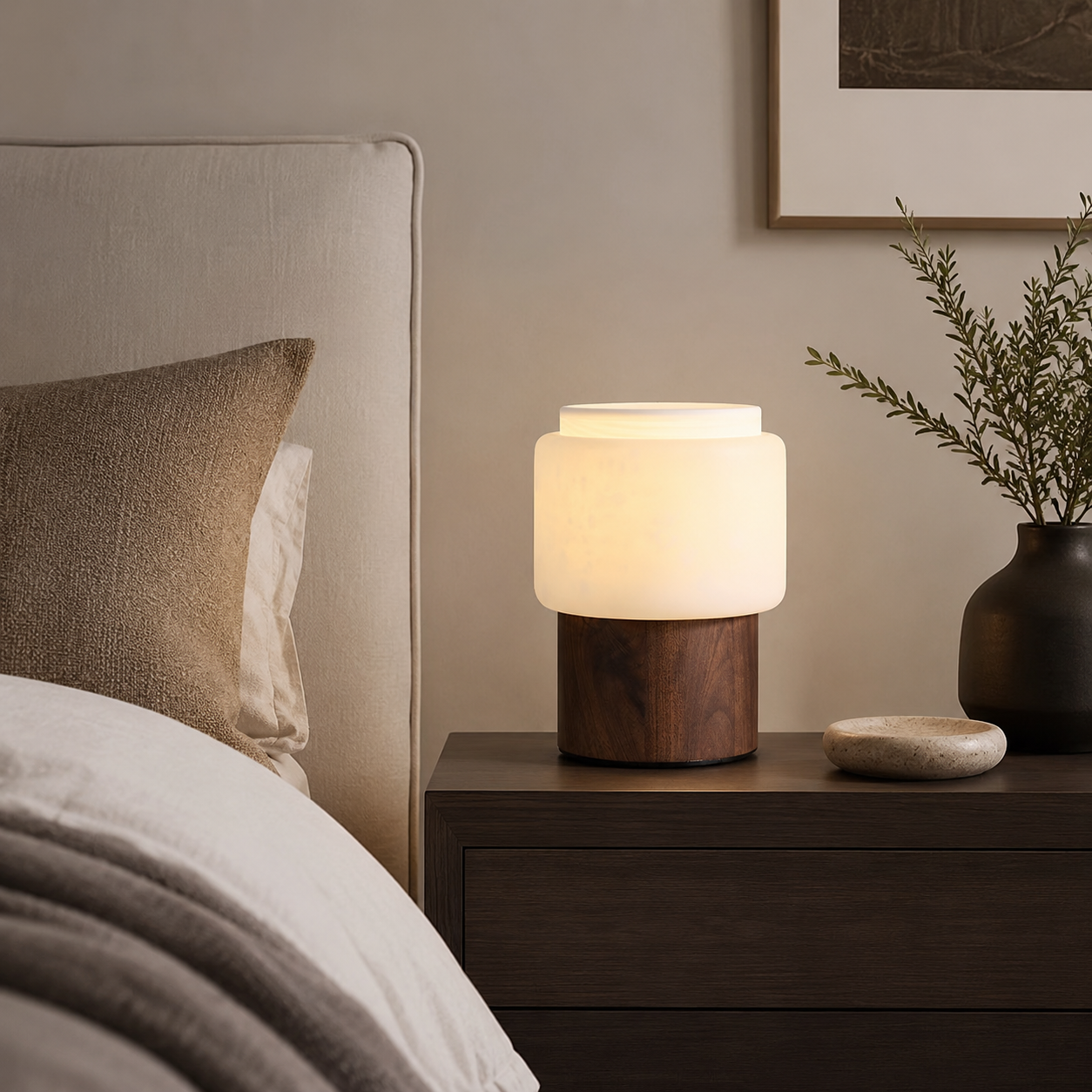 Walnut table lamp with frosted white shade and dark wood base on side table