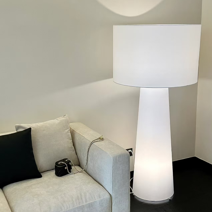 White fabric floor lamp with drum shade and smooth cylindrical stem