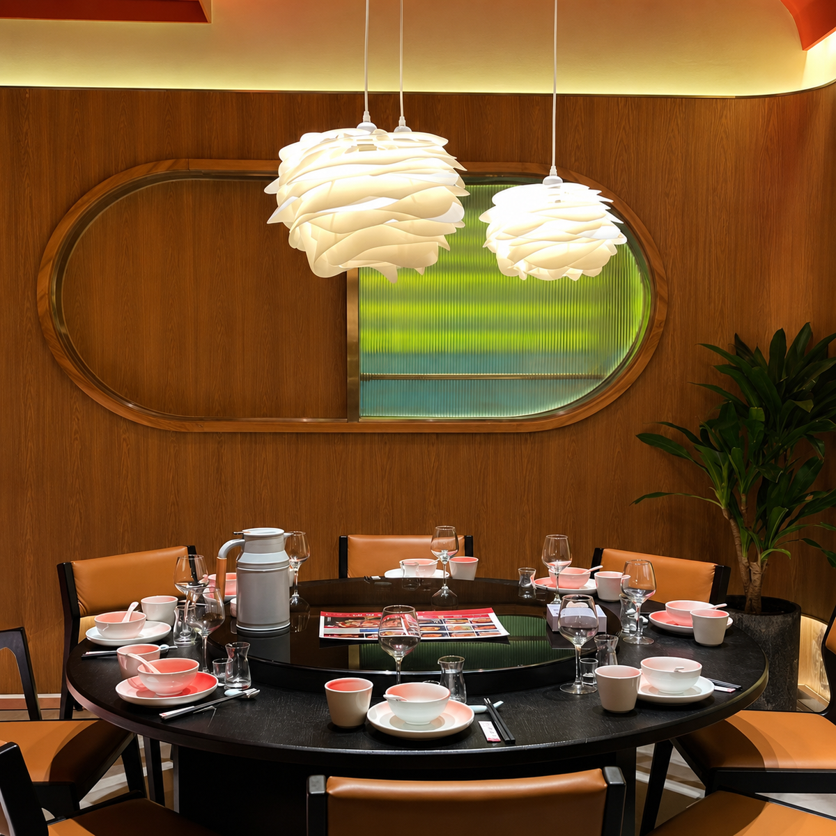 Two white petal swirl pendant lights with layered dome shades over dining table