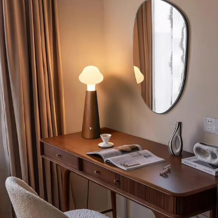 Cloud glass table lamp on dresser with frosted globe shade and wood base