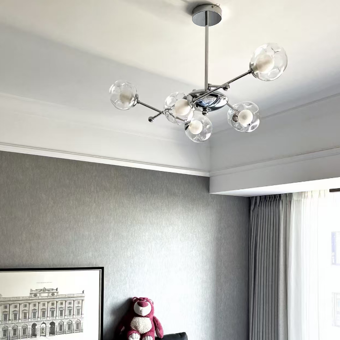 Ceiling-mounted balance globe chandelier with clear glass globes and chrome hardware