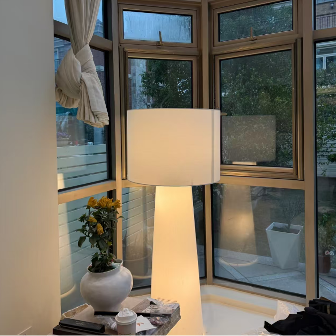 White fabric floor lamp with drum shade and tall tapered stand