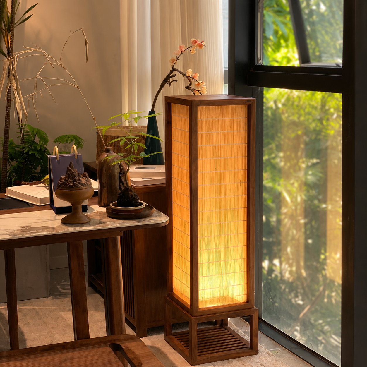 Wood framed floor lamp with glowing rectangular bamboo shade and recessed base shelf