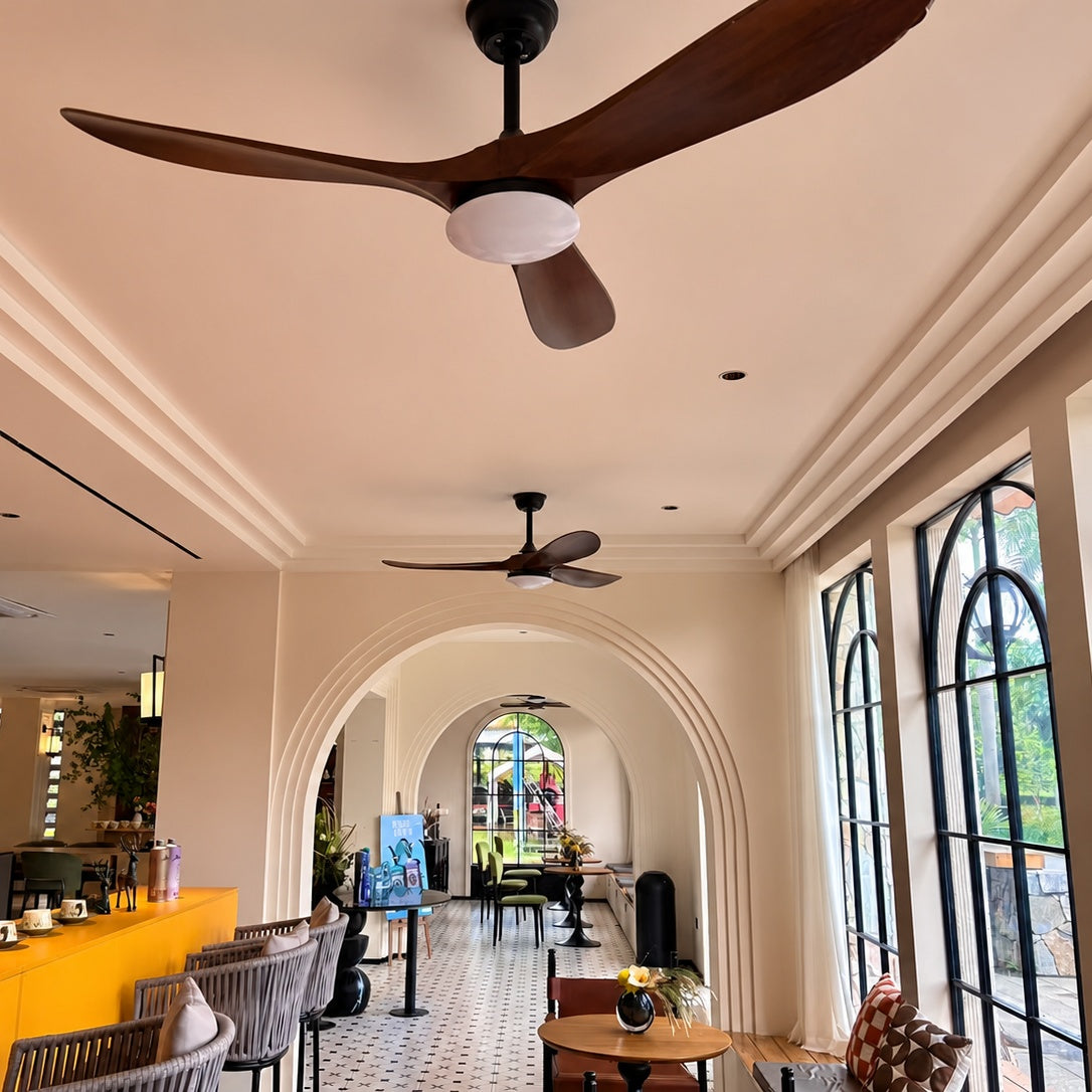Ceiling fan with dark brown blades and white frosted light shade on black base
